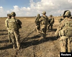 FILE - U.S. soldiers gather at a military base north of Mosul, Iraq, Jan. 4, 2017. U.S. forces have been deployed alongside Iraqi units to serve in an "Advise and Assist" role in the offensive against Islamic State militants in Mosul, in addition to providing air support.