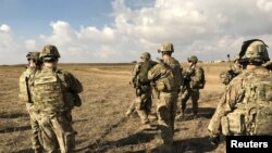 FILE - U.S. soldiers gather at a military base north of Mosul, Iraq, Jan. 4, 2017. The U.S. on Monday shut its Iraqi military headquarters controlling American ground operations against Islamic State. 