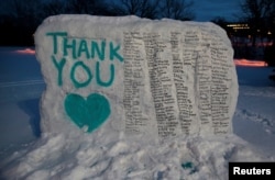 The boulder known as "the Rock" is seen, on the campus of Michigan State University, painted with the names of victims of Larry Nassar.