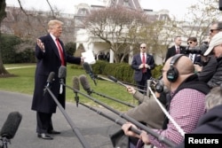 President Donald Trump talks to reporters as he departs on travel to Ohio from the White House in Washington, March 20, 2019.