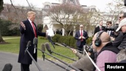 President Donald Trump talks to reporters as he departs on travel to Ohio from the White House in Washington, March 20, 2019.