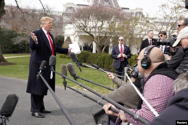 President Donald Trump talks to reporters as he departs on travel to Ohio from the White House in Washington, March 20, 2019.