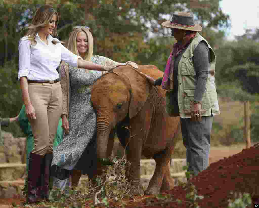 First lady Melania Trump with Margaret Kenyatta, Kenya's first lady, pets a baby elephant the at David Sheldrick Elephant & Rhino Orphanage at Nairobi National Park in Nairobi, Kenya, Oct. 5, 2018. 