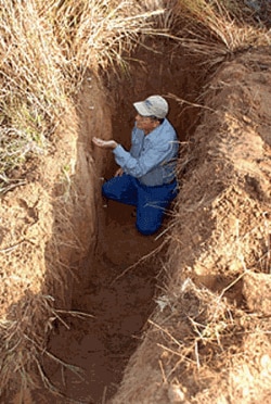 Soil scientist Ron Follett examines a soil profile beneath a native grassland site near Woodward, Oklahoma, before collecting samples for soil carbon analysis. USDA will commit up to $90 million dollars to Global Research Alliance to share results from