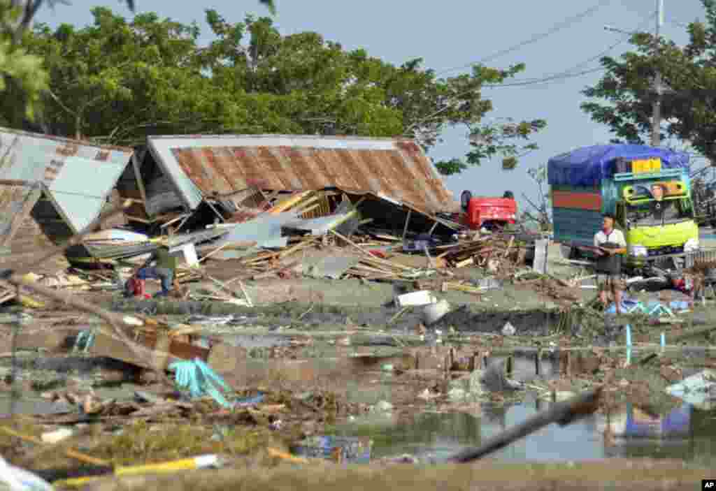 A man stands amid the damage caused by a tsunami in Palu, Central Sulawesi, Indonesia, Sept. 29, 2018. 