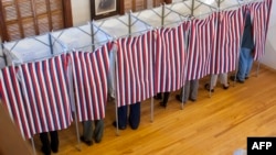 FILE - Voters cast their ballots at the Sutton town hall in the US presidential election, Nov. 8, 2016 in Sutton, New Hampshire. 