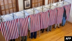 FILE - Voters cast their ballots at the Sutton town hall in the U.S. presidential election in Sutton, New Hampshire, Nov. 8, 2016. 