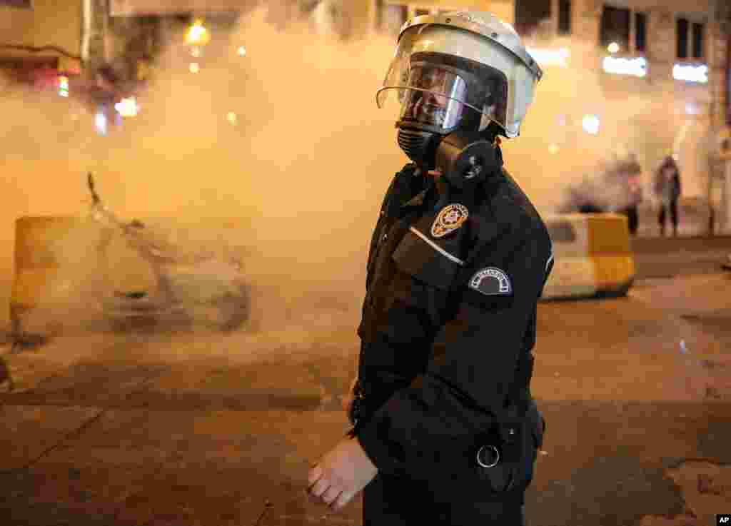 A police officer amid the protesting in Istanbul, Turkey, Oct. 7, 2014.