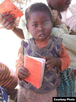 Parents and children in Malawi use health passports as a portable medical record. (Alain HY Cheng)