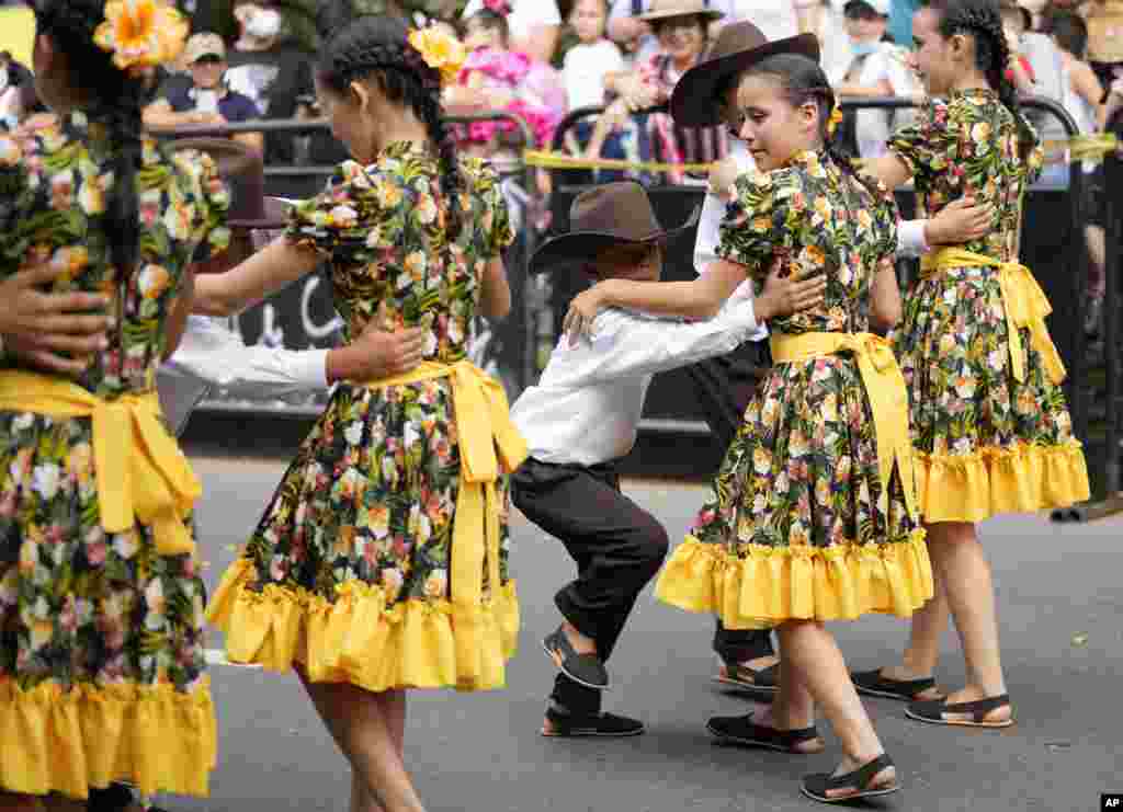 Folk dancers parade during the International Tournament of Joropo in Villavicencio, Colombia, Nov. 13, 2021.