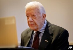 FILE - Former U.S. President Jimmy Carter is shown during a video interview via a laptop at a hotel in London, Feb. 2, 2016.