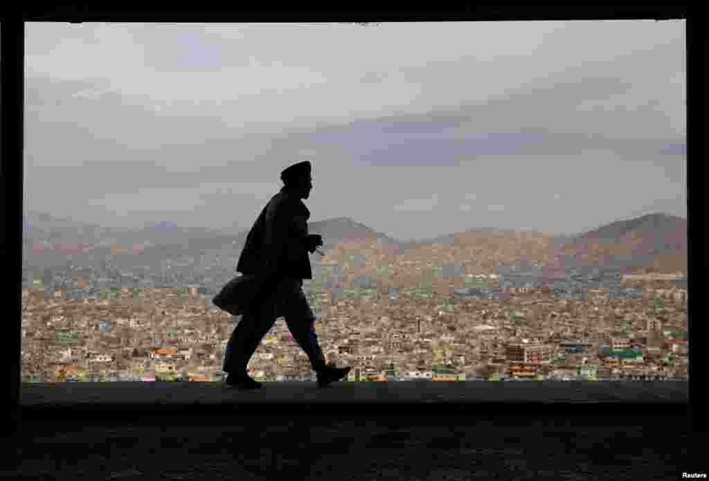 A man walks on a hilltop overlooking Kabul, Afghanistan.