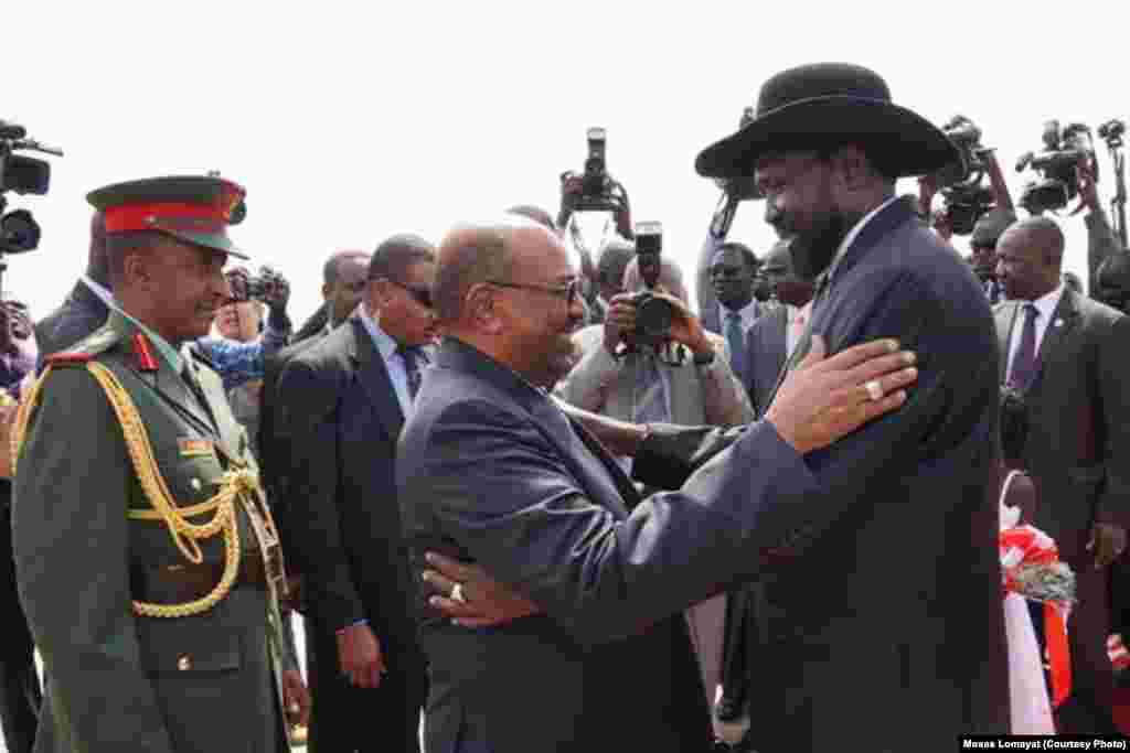 South Sudanese President Salva Kiir (r.) hugs his Sudanese counterpart Omar al Bashir as he arrives at Juba airport on Friday, April 12, 2013. The Sudanese president was visiting South Sudan for the first time since it split from Sudan in 2011.