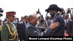 South Sudanese President Salva Kiir (r.) hugs his Sudanese counterpart Omar al Bashir as he arrives at Juba airport on Friday, April 12, 2013. The Sudanese president was visiting South Sudan for the first time since it split from Sudan in 2011.