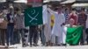 Kashmiri protesters hold Pakistani flags, one with swords and the word "jihad" written on it, during a protest in Srinagar, India, July 8, 2016. Youths in the Indian part of Kashmir protested allegations that Islamic preacher Zakir Naik was involved in making hate speeches.