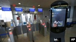 FILE - A U.S. Customs and Border Protection facial recognition device is ready to scan another passenger at a United Airlines gate.