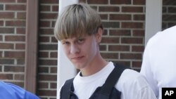 FILE - Dylann Roof is escorted from the Sheby Police Department in Shelby, North Carolina, June 18, 2016.
