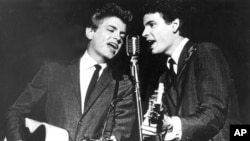 FILE - The Everly Brothers, Phil, left, and Don, perform on stage, July 31, 1964. 