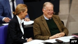 The co-leaders of the Alternative for Germany (AfD) far-right party, Alexander Gauland and Alice Weidel, laugh as they attend a session at the Bundestag lower house of Parliament in Berlin, Nov. 21, 2017.
