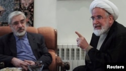 FILE - Iranian opposition leader Mirhossein Mousavi (L) meets with pro-reform cleric Mehdi Karoubi in Tehran, Oct. 12, 2009. 