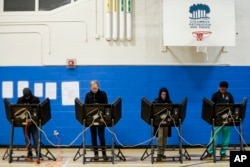 Voters cast their ballots at the Tuttle Park Recreation Center polling location, Nov. 6, 2018, in Columbus, Ohio. Across the country, voters headed to the polls Tuesday in one of the most high-profile midterm elections in years.