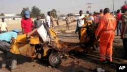 FILE - People clear debris after an explosion in Maiduguri, Nigeria, Oct. 29, 2016. Twin explosions from female suicide bombers suspected to be with Boko Haram killed nine people and injured more than 20 in Nigeria's northeastern city of Maiduguri, officials and witnesses said.