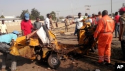 FILE - People clear debris after an explosion in Maiduguri, Nigeria, Oct. 29, 2016. Twin explosions from female suicide bombers suspected to be with Boko Haram killed nine people and injured more than 20 in Maiduguri.