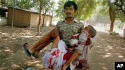 A man injured in bomb blasts is carried outside the venue of a political rally in Patna, India, Oct. 27, 2013. 