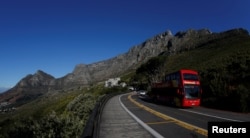 A tour bus carries visitors to Table Mountain in Cape Town, South Africa, August 5, 2017.