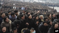 Pyongyang citizens grieve as they visit a portrait of late North Korean leader Kim Jong Il on display in the plaza of the Pyongyang Indoor Stadium in Pyongyang, North Korea, December 21, 2011.