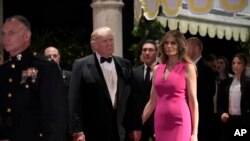 President Donald Trump and first lady Melania Trump arrive for the 60th annual Red Cross Gala at Trump's Mar-a-Lago resort in Palm Beach, Florida, Feb. 4, 2017. Fueled by Trump's controversial immigration orders, activists are calling for charities to move or cancel planned galas at the resort.
