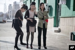 Waitresses wait outside a restaurant in Pyongyang, North Korea, April 12, 2017.