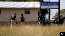 Law enforcement officials investigate the scene of a shooting at the First Baptist Church of Sutherland Springs, Nov. 6, 2017, in Sutherland Springs, Texas. 