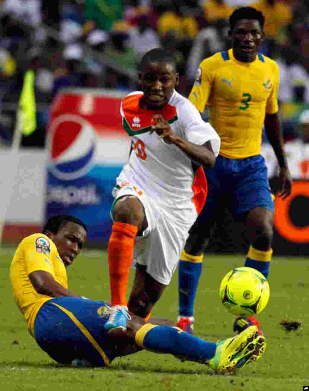 Niger'a Mountari is tackled by Gabon's Ondo during their African Cup of Nations soccer match in Libreville