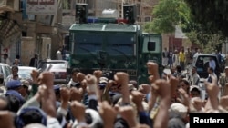 Protesters loyal to the Houthi Shi'ite group are blocked by riot police near the Cabinet's headquarters as they demonstrate to demand for the resignation of the government in Sana'a, Yemen, Sept. 1, 2014.