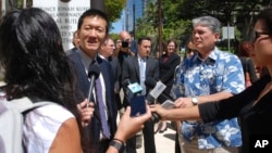 Hawaii Attorney General Douglas Chin speaks outside federal court in Honolulu, March 29, 2017. 