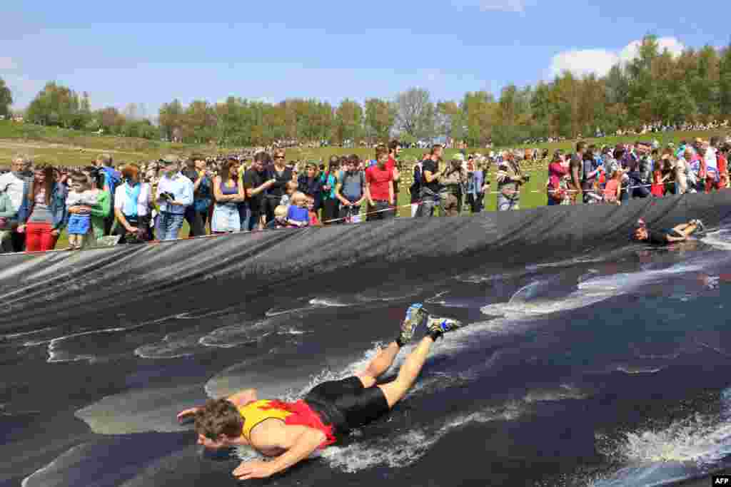 Participants compete in the second edition of the Spartacus survival run in Boom, Belgium. 