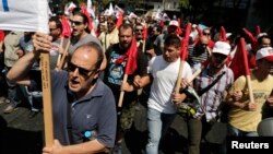 Supporters of the Communist-affiliated trade union PAME take part in an anti-austerity rally during a 24-hour general strike, in Athens, July, 16, 2013.