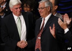 FILE - In this July 21, 2010, photo, Sen. Chris Dodd, D-Conn., left, and Rep. Barney Frank, D-Mass., shake hands at the signing ceremony for the Dodd-Frank Wall Street Reform and Consumer Protection financial overhaul bill in Washington.