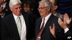 FILE - In this July 21, 2010, photo, Sen. Chris Dodd, D-Conn., left, and Rep. Barney Frank, D-Mass., shake hands at the signing ceremony for the Dodd-Frank Wall Street Reform and Consumer Protection Act in Washington. 