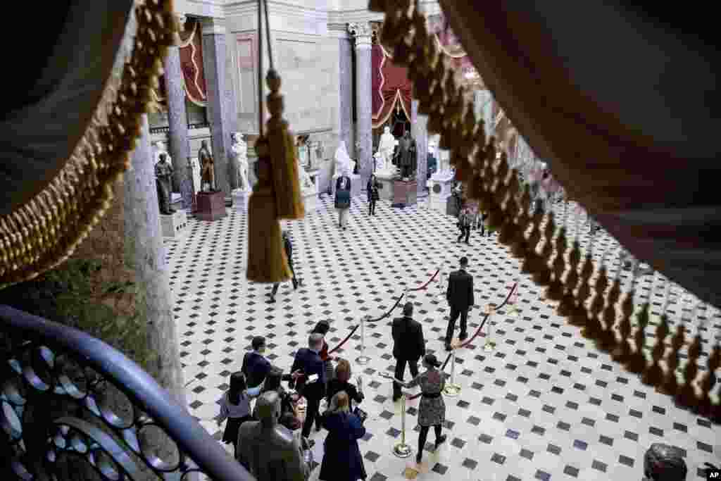 House Speaker Nancy Pelosi, bottom center, walks to the House Chamber as the House of Representatives takes up articles of impeachment against President Donald Trump, on Capitol Hill in Washington.