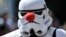 A cosplayer dressed as a Star Wars stormtrooper wears a red nose at a cosplayer meeting in Bottrop, Germany, Saturday, June 15, 2019. (AP Photo/Martin Meissner)