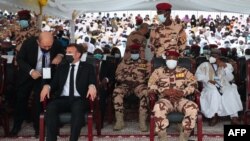 Le président français Emmanuel Macron assis aux côtés de Mahamat Idriss Deby aux funérailles d'État du défunt président tchadien Idriss Deby Itno, à N'Djamena, le 23 avril 2021.