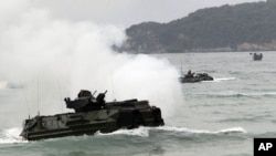 FILE - Amphibious assault vehicles prepare to hit the ground at joint military exercise 'Cobra Gold' on Hat Yao beach in Chonburi province, eastern Thailand, February 10, 2012. 