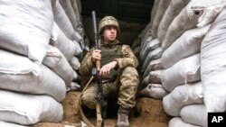 A Ukrainian soldier is pictured in a trench on the line of separation from pro-Russian rebels, Mariupol, Donetsk region, Ukraine, Jan. 21, 2022. Washington and its allies have repeatedly promised that Russia would face consequences if it invaded Ukraine.