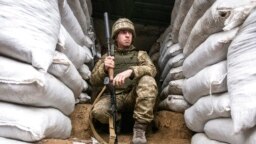A Ukrainian soldier is pictured in a trench on the line of separation from pro-Russian rebels, Mariupol, Donetsk region, Ukraine, Jan. 21, 2022. Washington and its allies have repeatedly promised that Russia would face consequences if it invaded Ukraine.