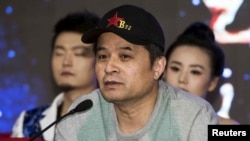 FILE - Bi Fujian, an anchor of China Central Television (CCTV), speaks during a news conference in Beijing.