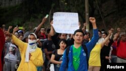 People support Honduran police during a strike to demand higher wages and rest after working extra hours due to protests caused by the delay in vote counting in the general election, at their headquarters in Tegucigalpa, Honduras, Dec. 4, 2017.