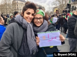 Algerian Yasmine Bouaouiche (R), protesting in Paris, wants France to cut ties with Algeria's government.