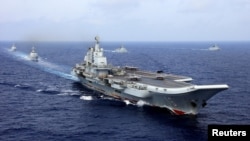 FILE - China's aircraft carrier Liaoning takes part in a military drill of Chinese People's Liberation Army (PLA) Navy in the western Pacific Ocean, April 18, 2018.